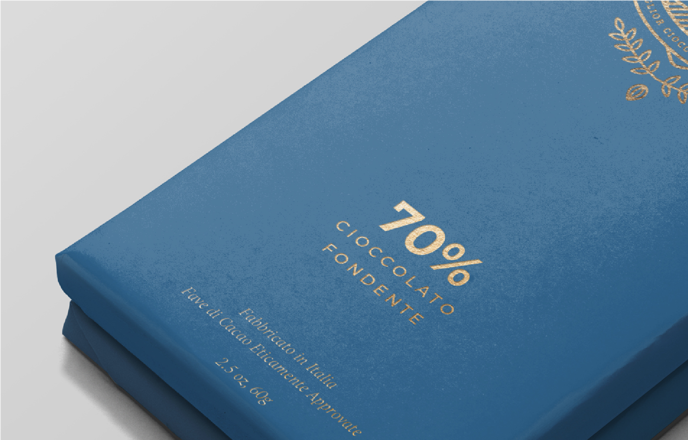 A blue chocolate bar wrapper with gold text that reads 70% cioccolato fondente. Additional text below indicates the chocolate is made in Italy and contains 70% cocoa.