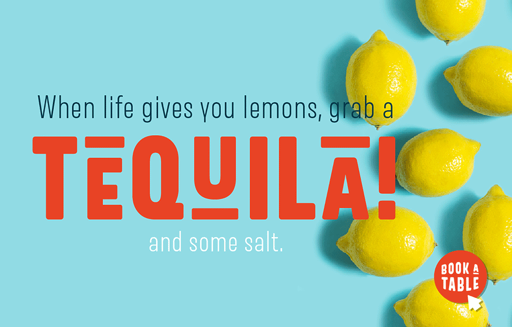 Whole lemons on a blue background with text: “When life gives you lemons, grab a TEQUILA! and some salt.” A red button in the corner says, “BOOK A TABLE.”.