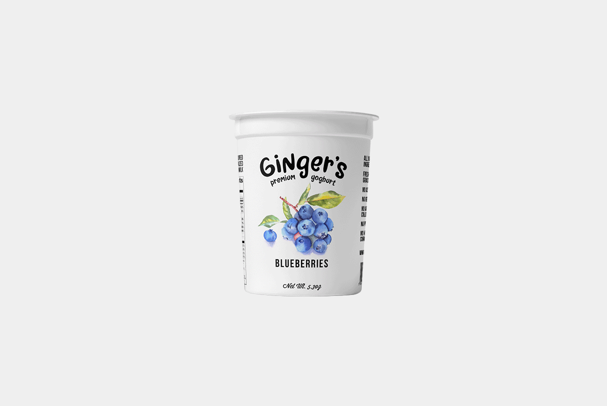 A white yogurt container labeled Gingers Premium Yogurt designed by Sandra Tay with illustration of fruits.