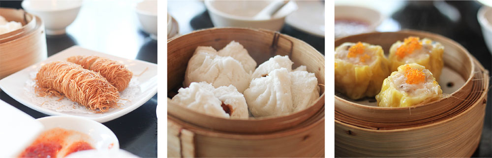 Three types of dim sum: fried noodle-wrapped rolls on a plate, steamed white buns in a bamboo basket, and yellow siu mai dumplings topped with roe in another bamboo basket, all on a table with dipping sauces.