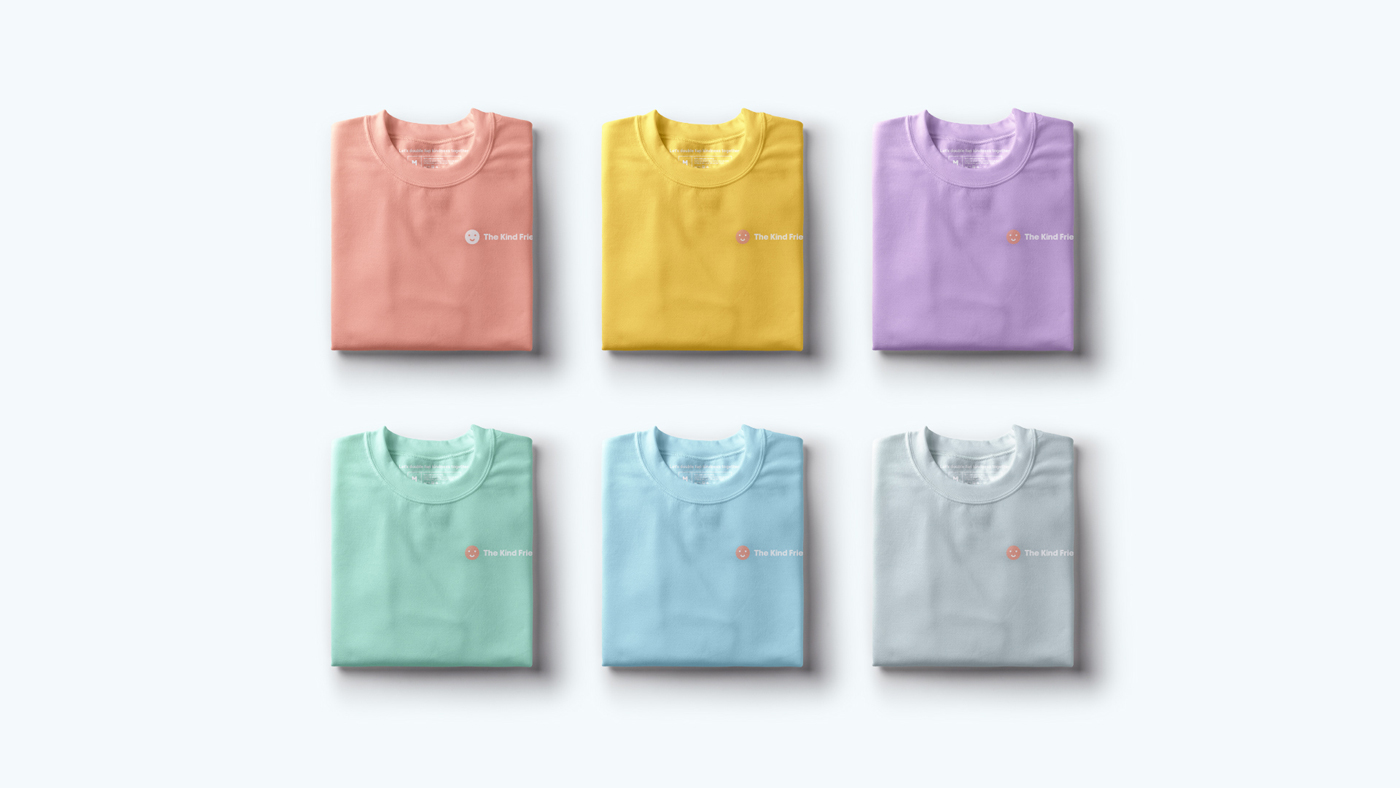 Six neatly folded t-shirts in pastel colors (pink, yellow, purple, mint, blue, and gray), each featuring a small logo on the left chest, arranged in two rows of three on a light background.