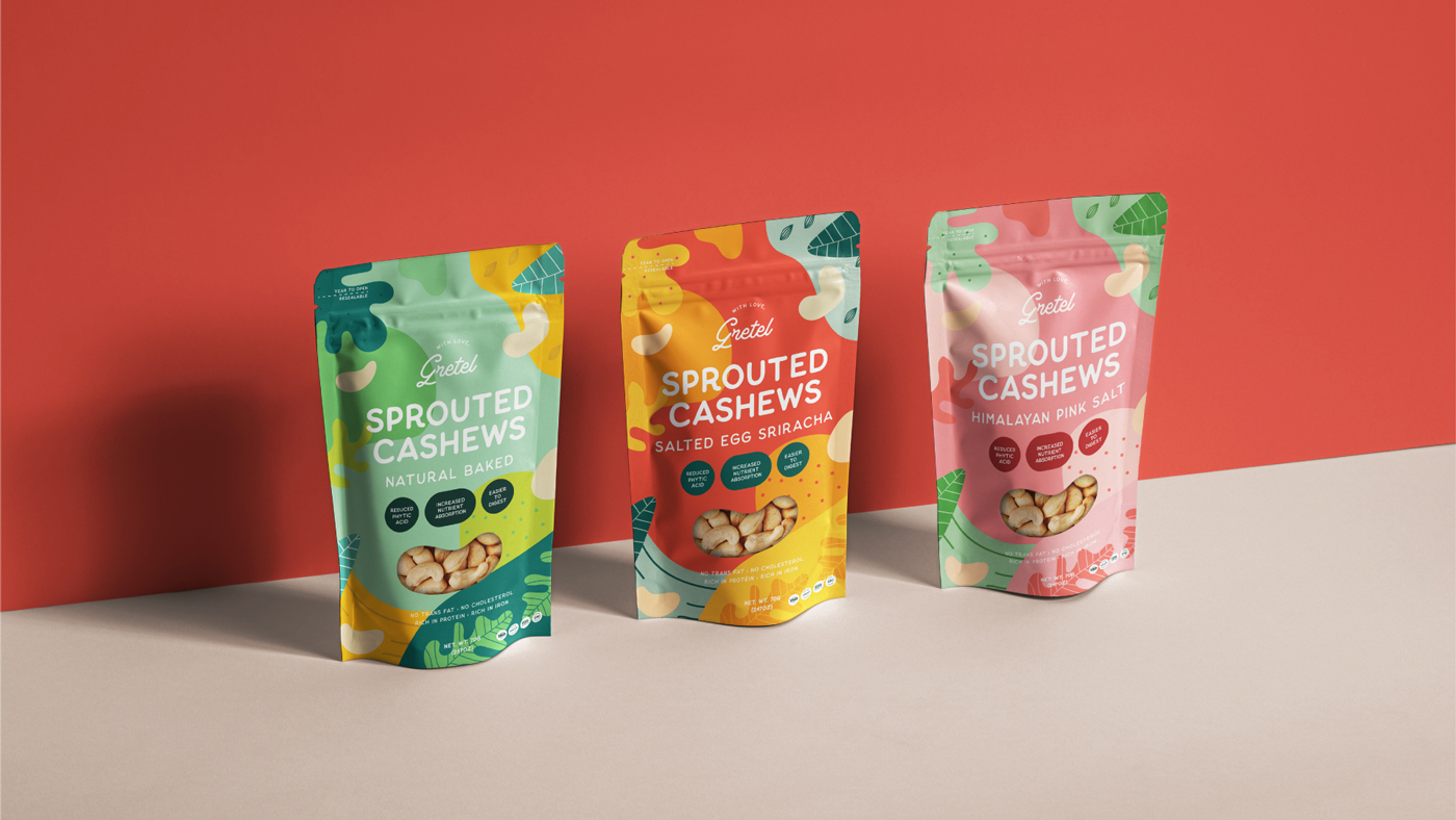 Three colourful stand-up pouches of With Love, Gretel sprouted cashews Natural Baked, Salted Egg Sriracha, and Himalayan Pink Salt designed by Sandra Tay, displayed upright against a red and beige background.